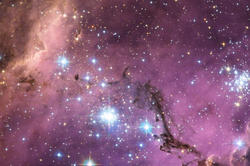 Nearly 200 000 light-years from Earth, the Large Magellanic Cloud, a satellite galaxy of the Milky Way, floats in space, in a long and slow dance around our galaxy. As the Milky Way’s gravity gently tugs on its neighbour’s gas clouds, they collapse to form new stars. In turn, these light up the gas clouds in a kaleidoscope of colours, visible in this image from the NASA/ESA Hubble Space Telescope.