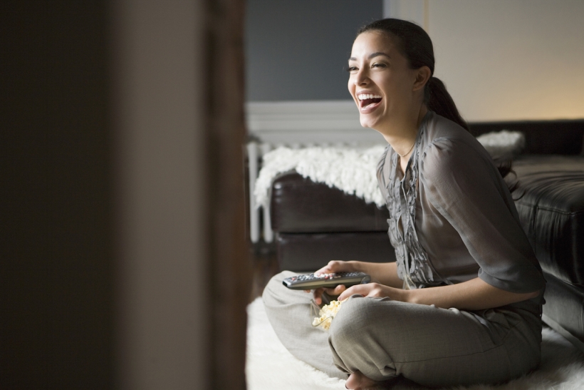 Young woman using a remote control